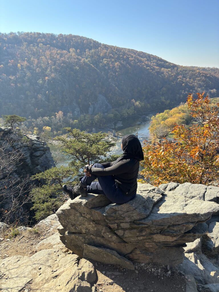 Black woman in hijab posing in front of the Maryland Heights Overlook