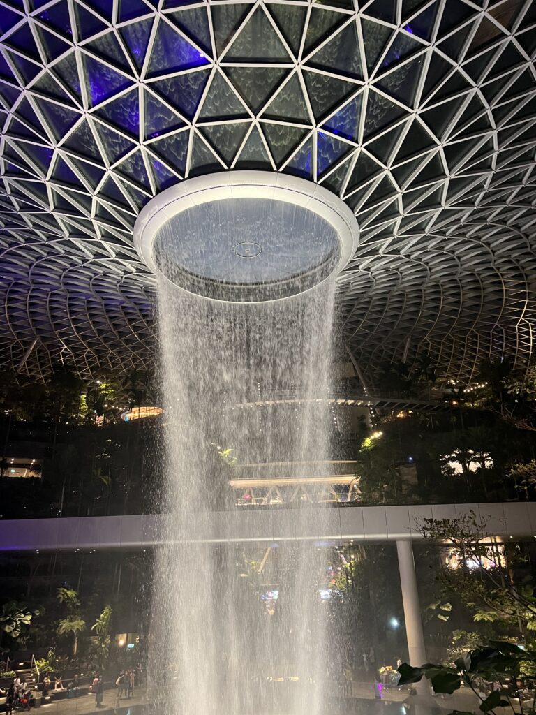 water is flowing out of the rain vortex, the word's tallest indoor waterfall