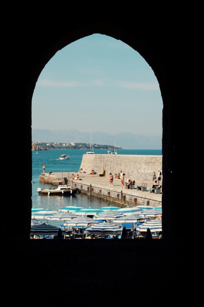 traditional sicilian window's view of Cefalu beach in Italy