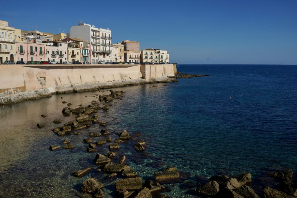 Photo of Italian coastal town and rocks near the shore