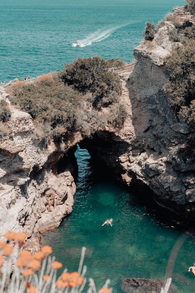 aerial view of a person swimming in the sea in bagni regina giovanna sorrento italy