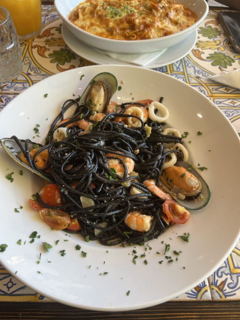 seafood pasta with black noodles at a restaurant near Benagil Cave