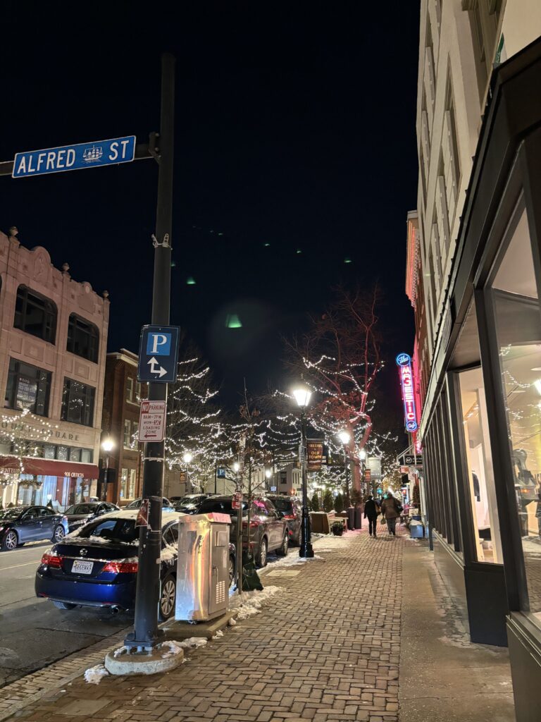 Old Town Alexandria streets at night. You can see some white string lights on the street poles