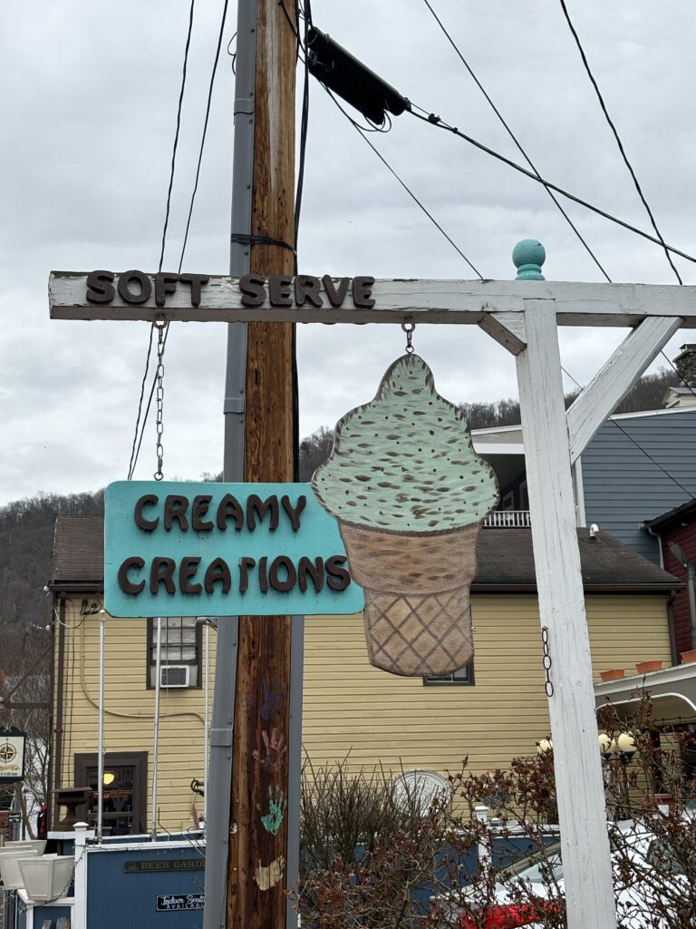 sign saying Creamy Creations with artwork of a vanilla ice cream cone