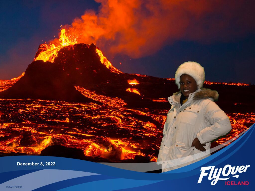 the image of a Black woman in beige coat and fluffy white hat  photoshopped in front of an active volcano with the Fly OVer logo in the corner 