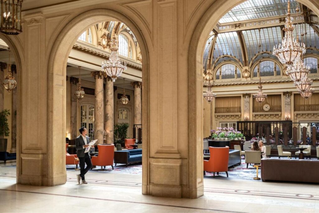 luxurious looking lobby with very high ceilings and detailed awning at Palace Hotel in San Francisco 