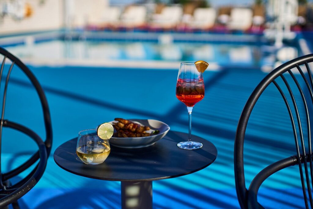 wine glass and snacks by the pool