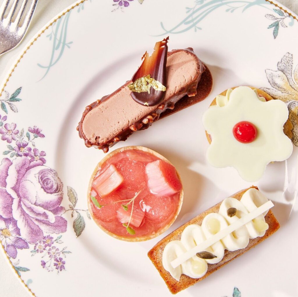 4 different spring inspired pastries and desserts on porcelain plate with tiny flowers on them