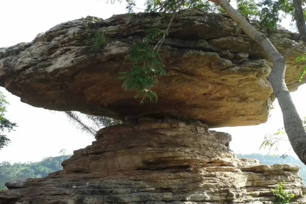 a large rock on top of a more narrow rock that looks similar to a umbrella 