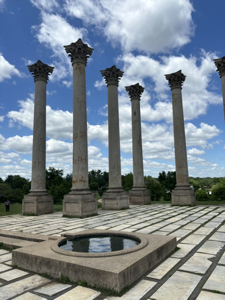 large columns with a small pool on a sunny day